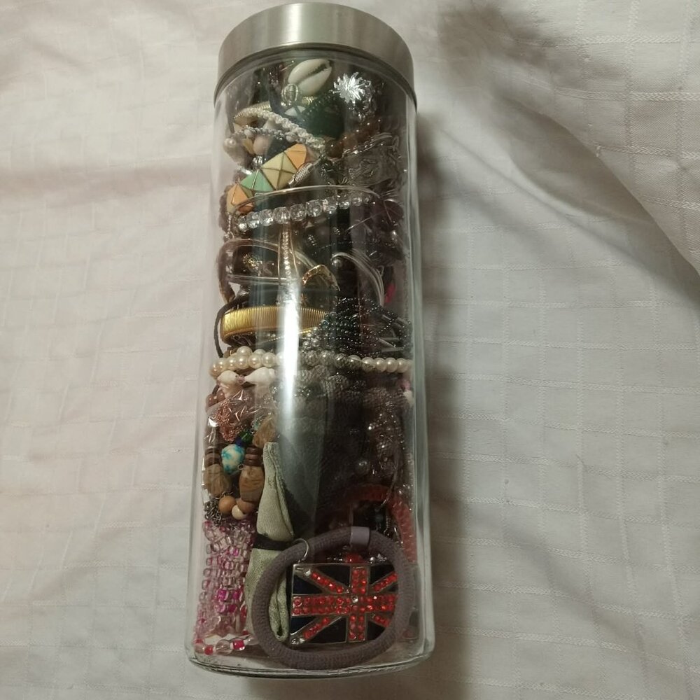 A stunning collection of jewelry in a big big big and heavy glass jar.